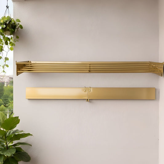 Gold towel racks on a white wall with potted plants below
