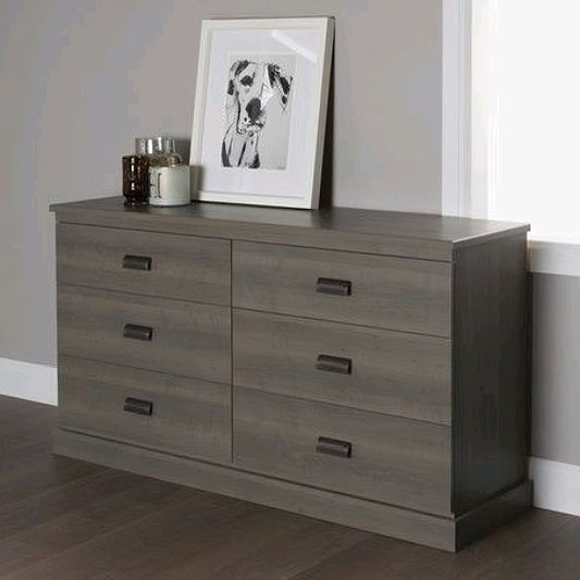 Gray dresser with framed picture of a dog on a gray wall