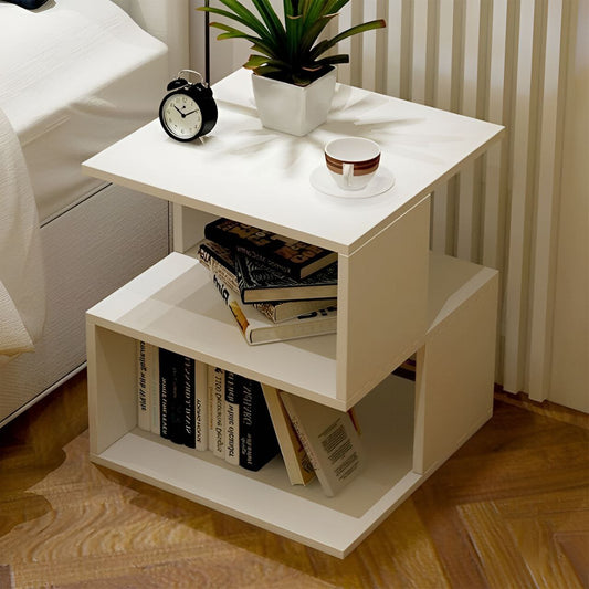 A white rectangular table unit with shelves, displaying a cup, a potted plant, and some books.