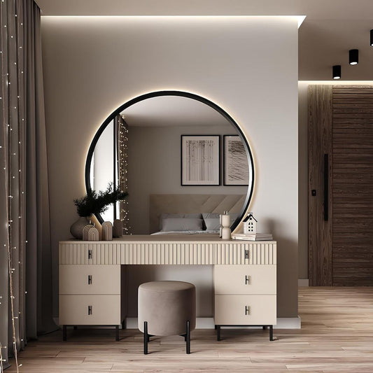 Modern bedroom with a round mirror, vanity table, and stool.