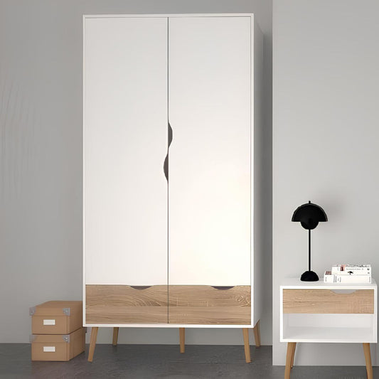 Modern wardrobe with wooden accents and a side table with a lamp against a gray wall.